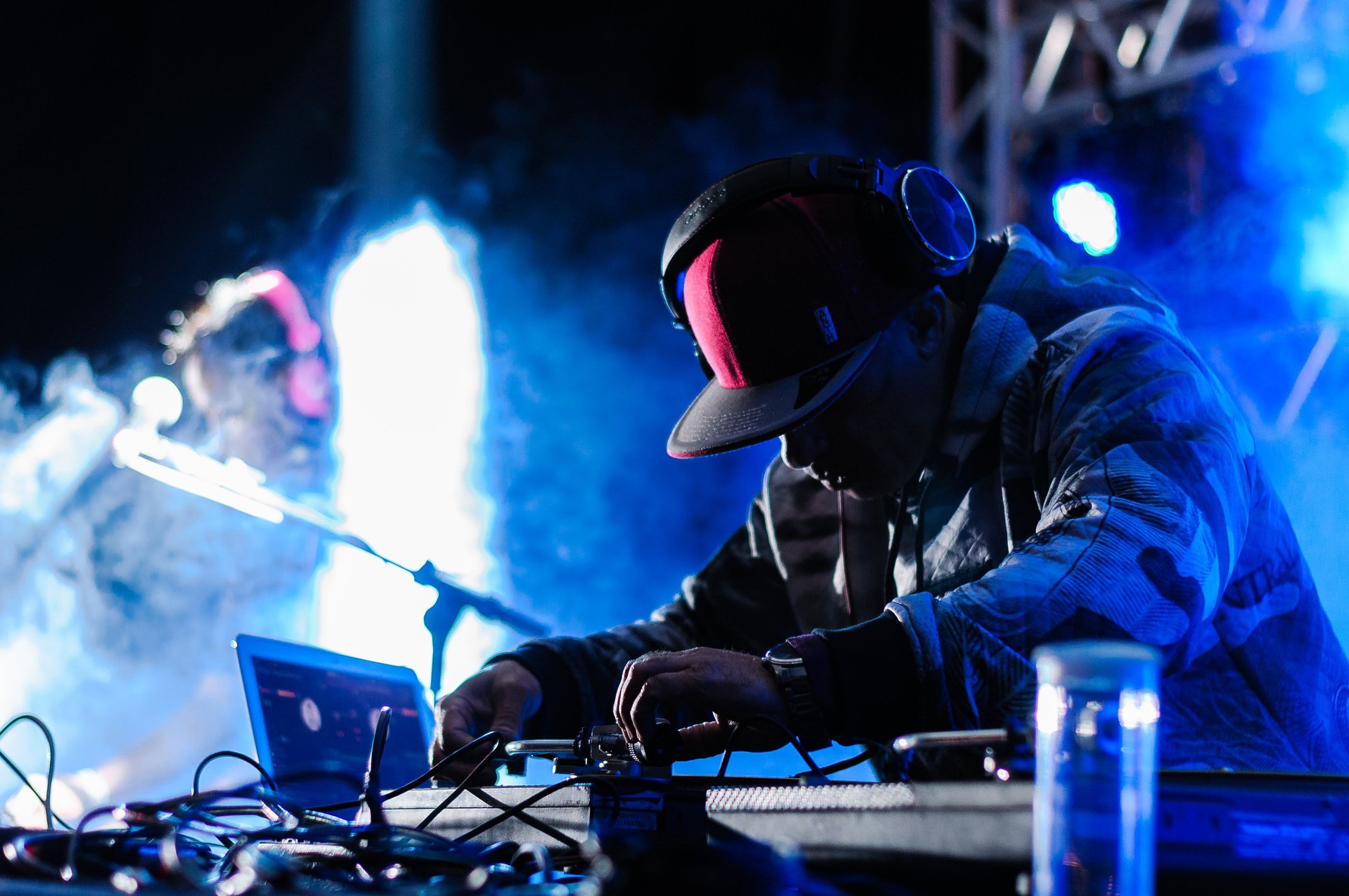 Black male DJ mixing music on console in club